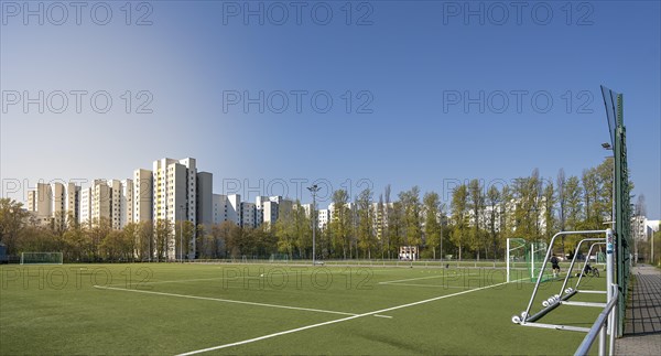 Football field and high-rise buildings in the Maerkisches Viertel residential area in Berlin Reinickendorf