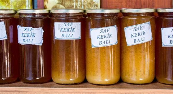 Glass jar of full of fresh honey with lid