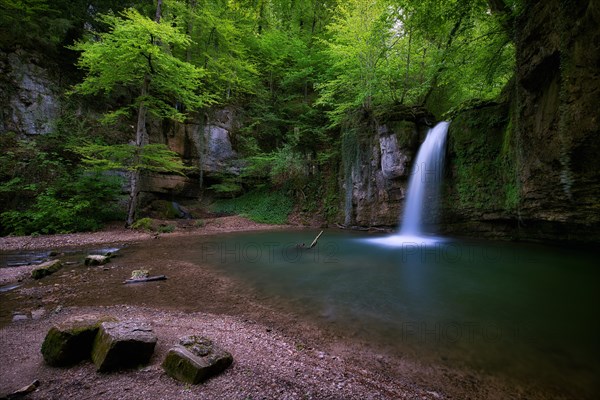 Waterfall in the forest with small pond near Kilchberg