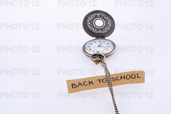 Back to school written title and a pocket watch