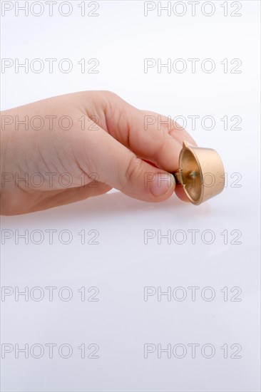 Child holding a tiny cooking pan in hand on a white background