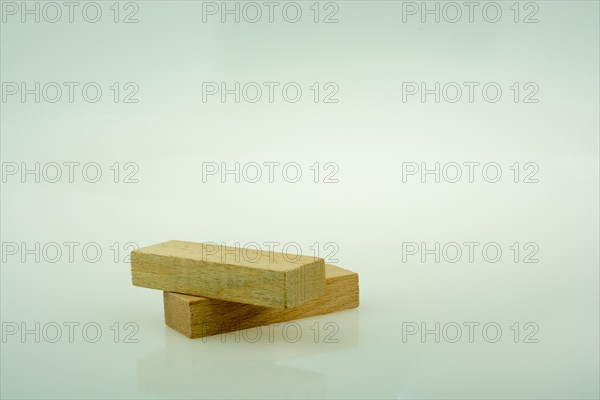 Wooden domino pieces positioned on white background