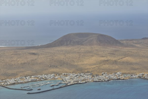 Montana del Mojon with harbour town on the island of La Graciosa from Mirador del Rio