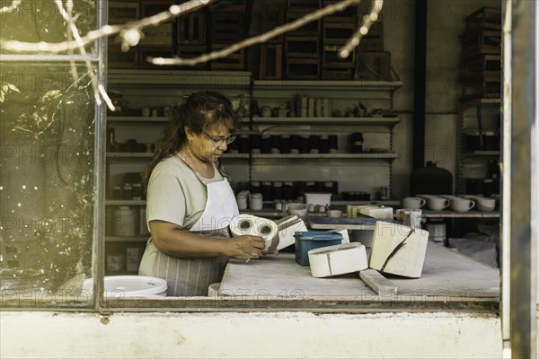 Master potter working in her studio. The process of creating pottery