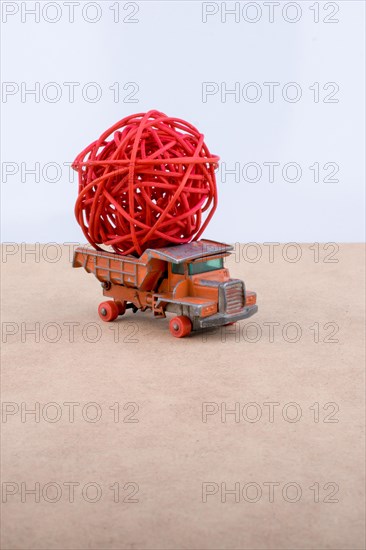 Toy car truck isolated on white and wooden background