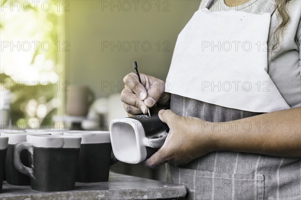 Clay workshop. The process of creating pottery. Master potter working in her studio