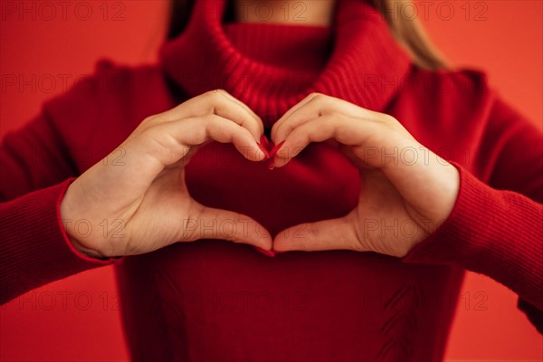 Female hands make a heart shape