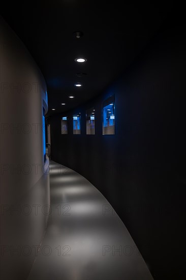 Illuminated Corridor with TV Screens in Switzerland