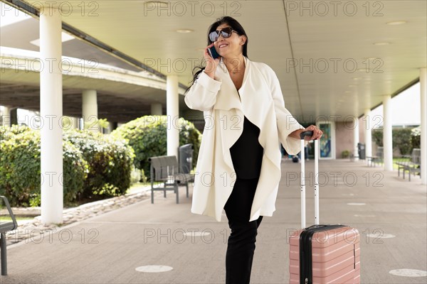 Female Walking Through Hallway of Airline Hub. Airport Terminal: Happy Traveling Woman Walks to Her Flight Gates
