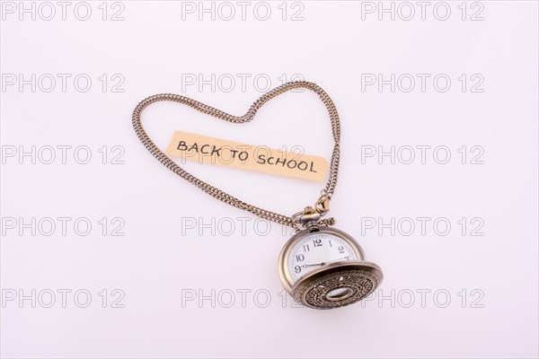 Heart shape formed by a pocket watch chain and back to school title