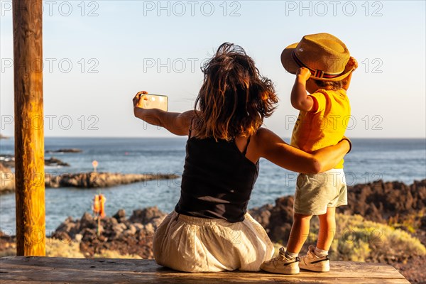 Mother and son on vacation taking a photo on Tacoron beach in El Hierro