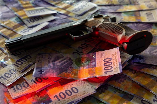 Elegant Semiautomatic 9mm Handgun with Swiss Helvetia Symbol Leaning on Swiss Franc 1000 Banknote in Switzerland