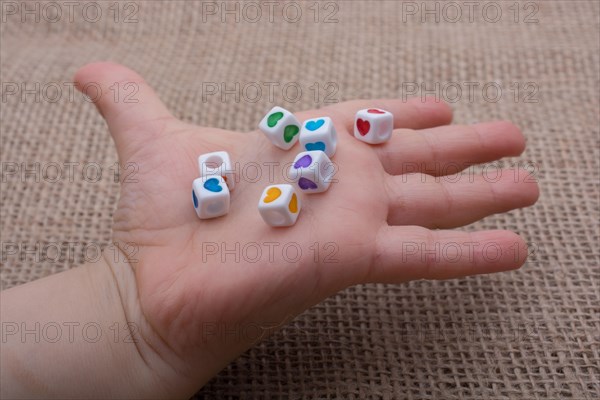 Colorful cubes with a heart in hand on canvas