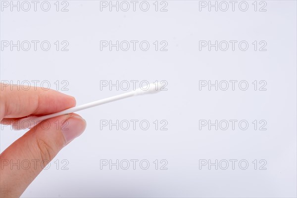 Single ear stick in hand isolated on white background