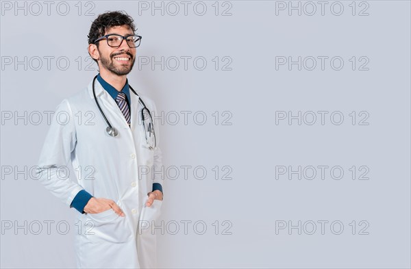 Portrait of happy doctor with hands in pockets isolated. Happy latin doctor with copy space isolated