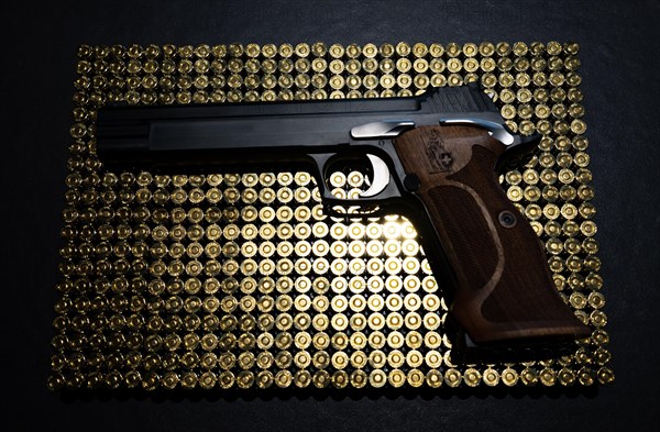 Elegant Semiautomatic 9mm Handgun with Swiss Helvetia Symbol Leaning on Bullet Ammunition in Switzerland