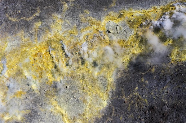 Smoking sulphur fumaroles at the crater rim