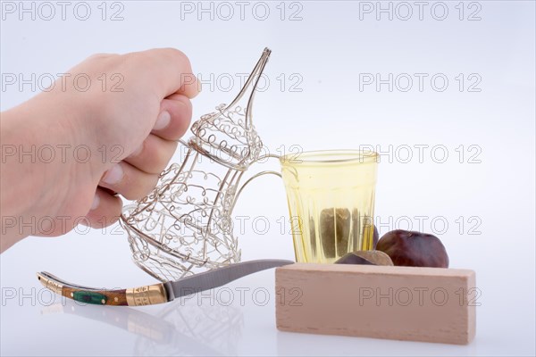 Silver color metal jug in hand a white background