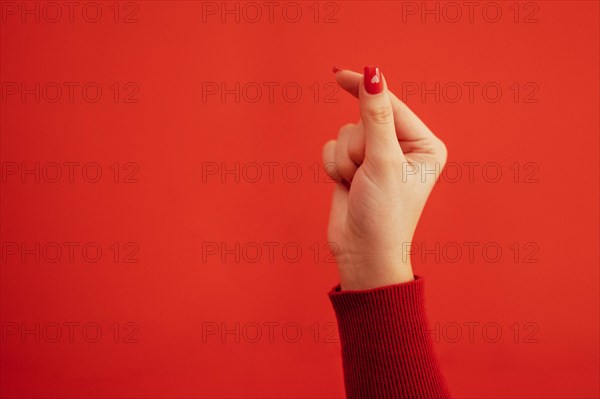 The Korean symbol for love is obvious. A woman's hand covers a heart. Place for text. Happy Valentine's day