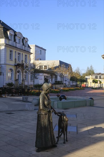 Statue of a woman with a goat on the main street