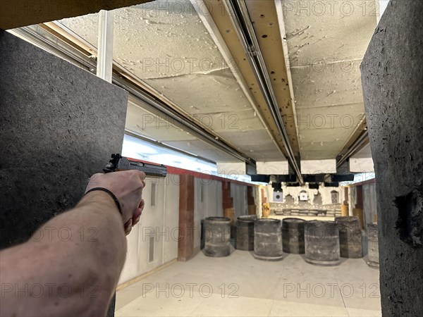 Man Shooting with a 9mm Handgun in Shooting Range in Switzerland