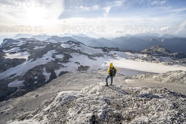 View of rocky plateau with glacier and remnants of snow