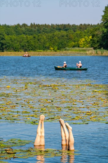 Sculpture of bathers doing a handstand