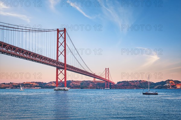 View of 25 de Abril Bridge famous tourist landmark over Tagus river