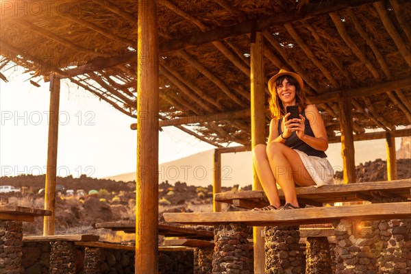 A female tourist at sunset smiling on Tacoron beach on El Hierro