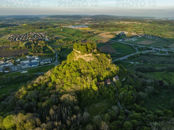 Aerial view of the Hegau volcano and the Hohenkraehen castle ruins illuminated by the evening sun