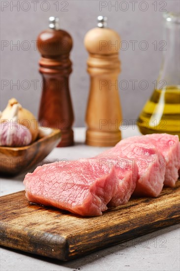 Closeup view of uncooked pork top loin roast cut on slices