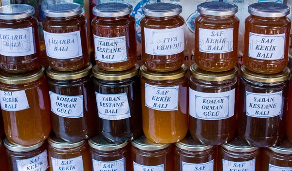 Glass jar of full of fresh honey with lid