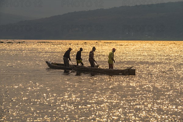 Fishermen at sunset on the Congo river