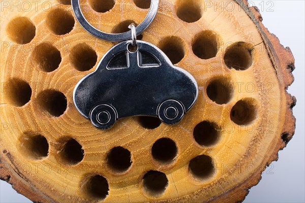 Automobile business concept with a metal car icon on wooden log