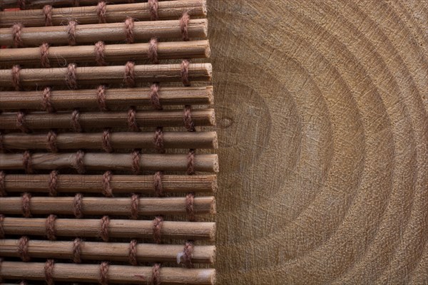 Wood log cut in round thin pieces and a brown color straw carpet