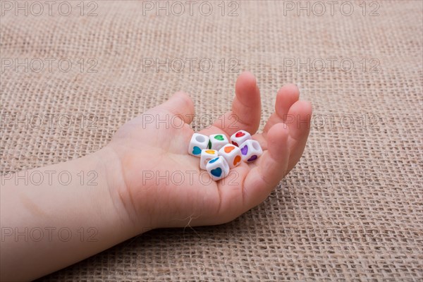 Colorful cubes with a heart in hand on canvas