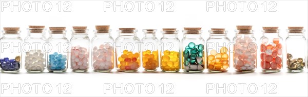 Seamless tileable rows of medicine and drug bottles with pills on a white background