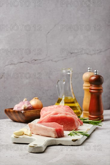 Fresh uncooked pork loin roast on grey background