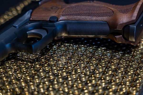 Elegant Semiautomatic 9mm Handgun with Swiss Helvetia Symbol Leaning on Bullet Ammunition in Switzerland