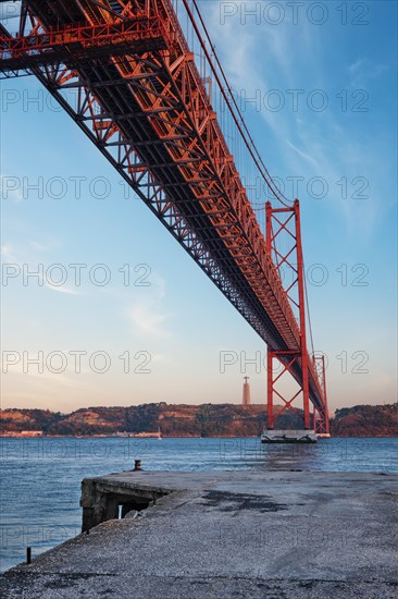 View from under of 25 de Abril Bridge famous tourist landmark over Tagus river