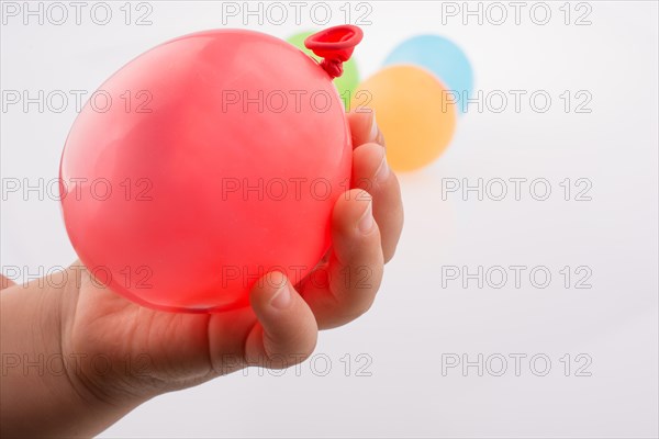 Hand holding a Colorful small balloon