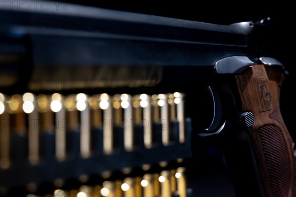 Elegant Semiautomatic 9mm Handgun with Swiss Helvetia Symbol Leaning on Bullet Ammunition in Switzerland