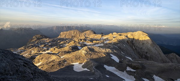 View of rocky plateau with remnants of snow in the evening light