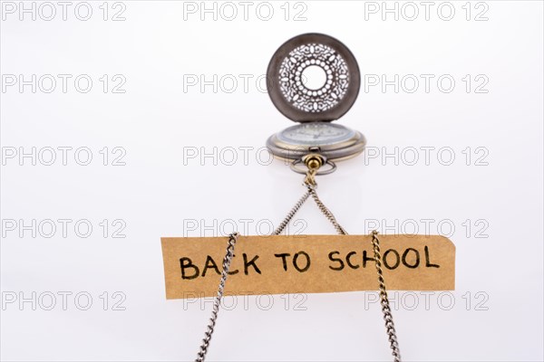 Back to school written title and a pocket watch