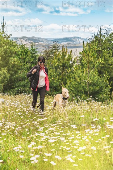 Adult woman playing with her dog