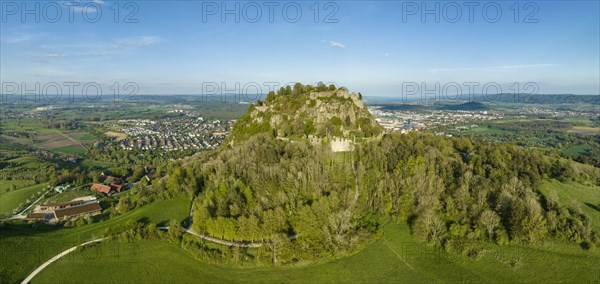 Aerial panorama of the volcanic cone Hohentwiel with the castle ruins illuminated by the evening sun