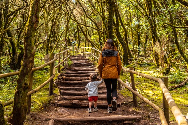 Mother and son trekking on some stairs along a path in the Garajonay natural park on La Gomera