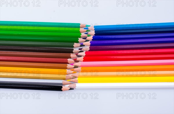 Color Pencils of Various colors placed on white background