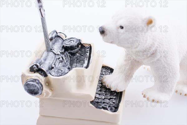 Polar bear cub on the roof of a model house mado of roof