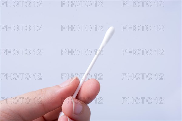 Single ear stick in hand isolated on white background